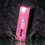 Fuhqe Stick box with splash photographed on near-black plum backdrop