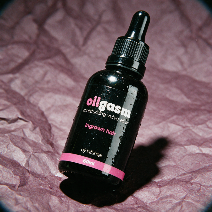 Oilgasm dark spot and ingrown hair eraser photographed on dark mauve plum backdrop