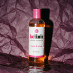 Helixir moisturizing body oil photographed on deep aubergine plum backdrop