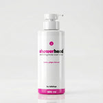 White bottle of 'showerhead' body wash scrub with pink accents on a light gray background
